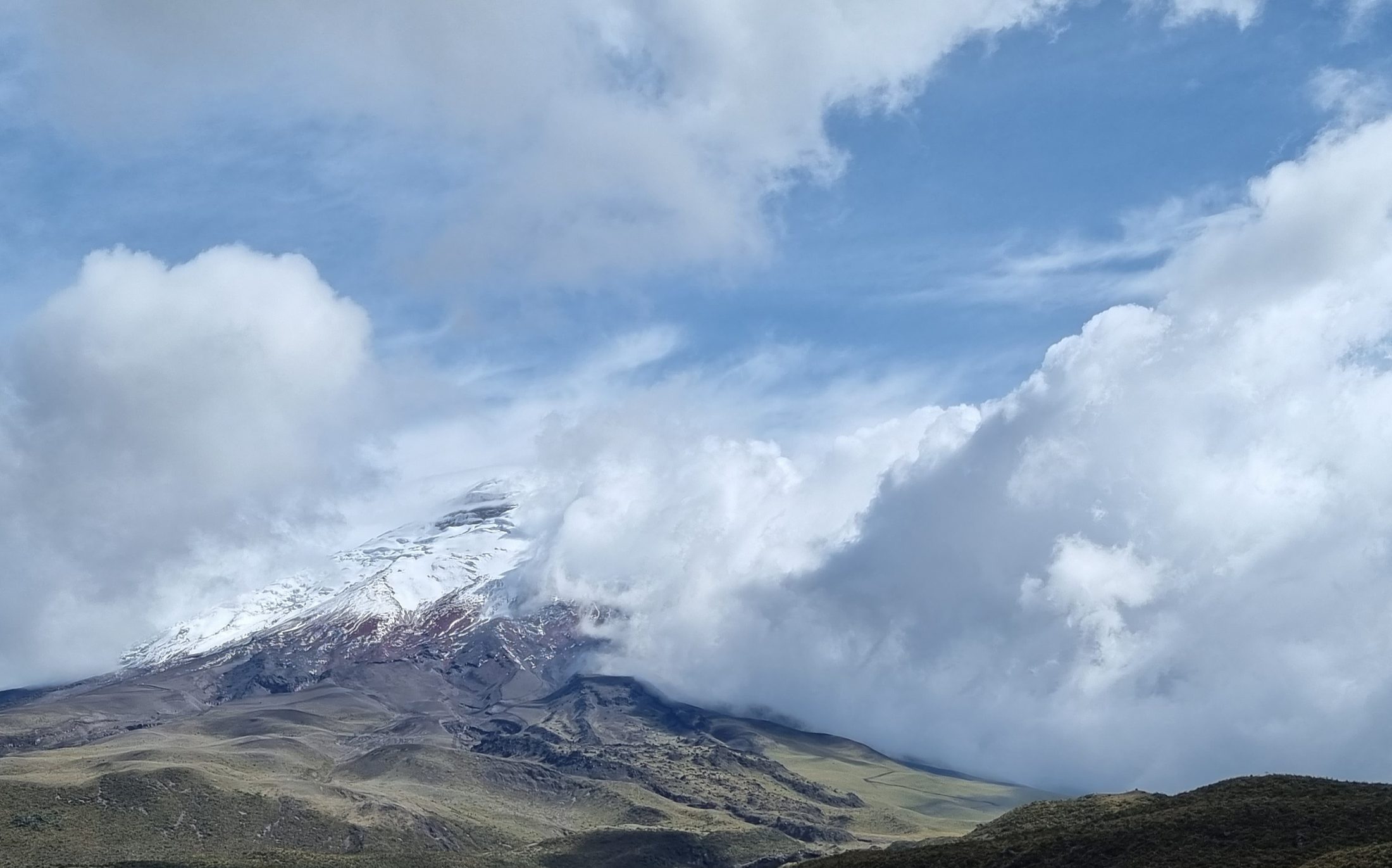 Snow-capped volcano half hidden in cloud